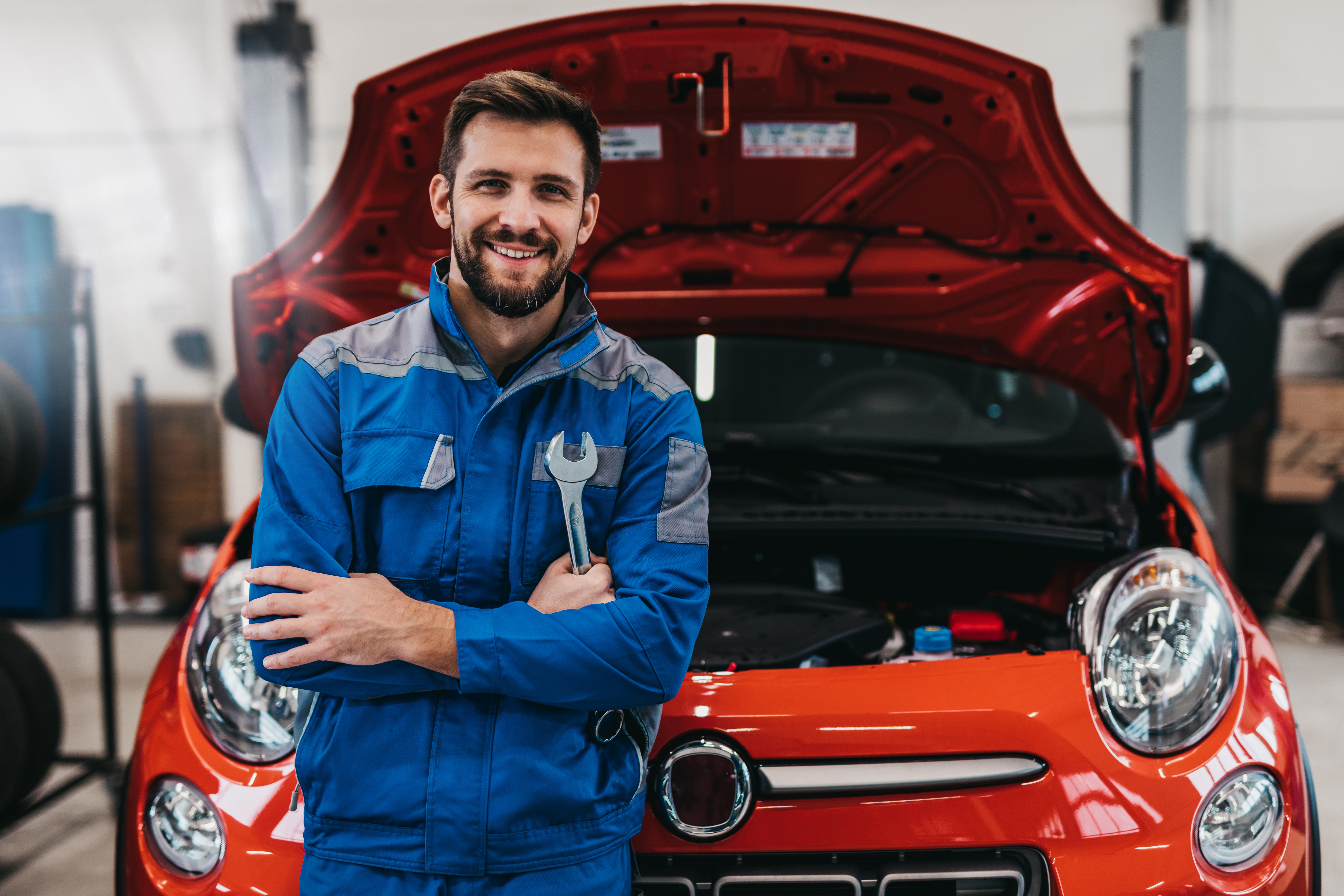 Who to trust when it comes to training Technician is standing in front of the opened car